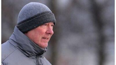 Manchester United manager Alex Ferguson watches his players during a team training session.