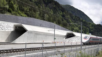 A train runs past at the northern entrance of the Gotthard Base Tunnel on the eve of its inauguration. Laurent Gillieron / EPA