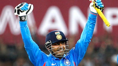 Virender Sehwag celebrates scoring his score of 219 against the West Indies.
