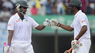 Bangladesh's Tamim Iqbal and Mahmudullah fist-hump during their third-wicket partnership on Wednesday during Day 2 of the first Test against South Africa in Chittagong. Munir uz Zaman / AFP / July 22, 2015