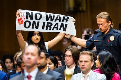 Police remove an anti-war protester at Tuesday's hearing. EPA