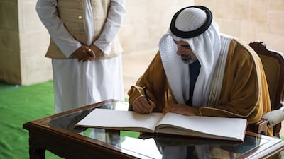 Sheikh Khaled concluded his visit to Raj Ghat memorial by writing in the guestbook. Photo: Abu Dhabi Media Office