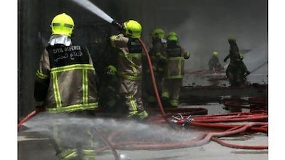 Firefighters tackle a blaze in Dubai last May. Female firefighters may be an idea whose time has come.