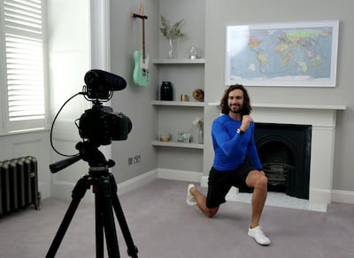 Joe Wicks, aka The Body Coach, teaches school children physical education live via YouTube. Getty Images