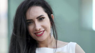 Monochrome styling for fluffy pet pooch and owner, Noor Al Ghanim and her pet Floof. Chris Whiteoak / The National