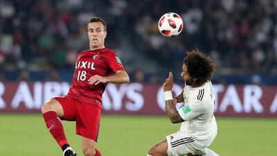 Marcelo of Real Madrid and Serginho of Antlers compete for the ball.