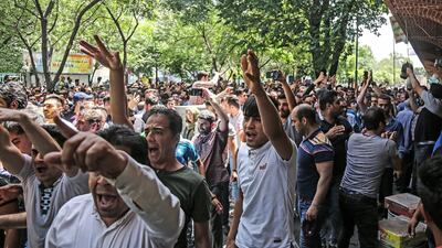Protesters chant in Tehran in anger over Iran's troubled economy. AP