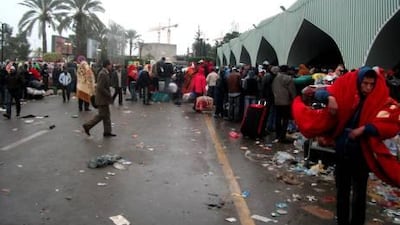 People outside Tripoli's International airport. Air passengers who managed to get out of Tripoli described a scene of chaos at the airport, with people shoving and climbing over each other to get on planes.