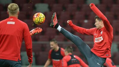 Robert Lewandowski of Poland aims a kick on Tuesday night during a team training session for their Euro 2016 qualifying match on Thursday night against Scotland. Bartlomiej Zborowski / EPA