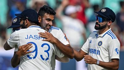 India's Ravichandran Ashwin, centre, celebrates with teammates after taking his 500th wicket, England's Zak Crawley. AFP