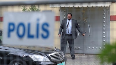 A Saudi official closes a door at Saudi Arabia's consulate in Istanbul, were Mr Khashoggi is believed to have gone missing. EPA