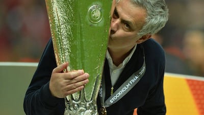 Manchester United manager Jose Mourinho celebrates with the Europa League trophy. Peter Powell / EPA