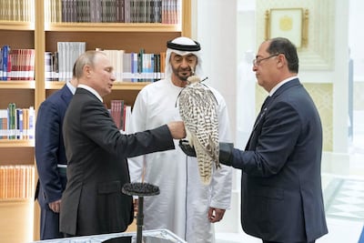Sheikh Mohamed and Vladimir Putin exchange gifts. Ministry of Presidential Affairs