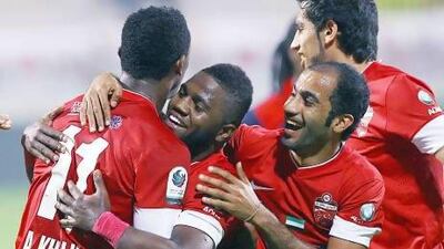 Al Ahli congratulate Ahmed Khalil, left, after he opened the scoring against Al Shaab. Satish Kumar / The National