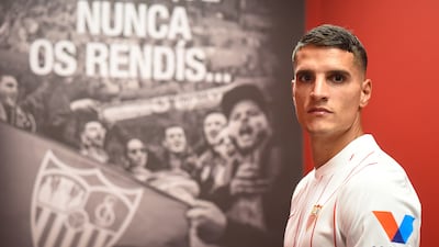A handout photo made available by Sevilla Footbal Club show Erik Lamela posing in a team strip after signing from Tottenham.