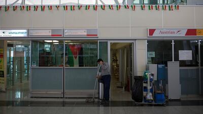 An airport employee cleans the floor in front of the closed airline desk at Erbil international airport in Iraq on September 30, 2017. Bram Janssen / AP