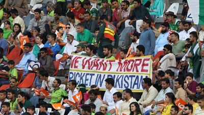 Pakistan cricket fans, brandishing a banner, pack out the Gaddafi Stadium for the second ODI against Zimbabwe on May 29, 2015. KM Chaudary / AP Photo