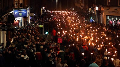 Members of the public take part during the torchlight procession on Edinburgh's Royal Mile for the start of the Hogmanay celebrations. PA/AP