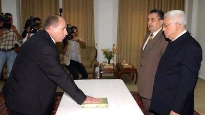 Palestinian leader Mahmoud Abbas (R) attends the swearing in of his friend and attorney general Ahmad Al Mughani. Mr Mughani has ordered the detention of journalists and has blocked access to websites opposed to Mr Abbas.