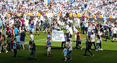 Manchester City fans hold up a sign reading 'Football Aside Get Well Soon Fergie' in reference to Alex Ferguson. Andy Hampson / AP Photo