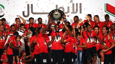 Al Ahli celebrate with the Arabian Gulf League trophy after their match against Al Dhafra at Rashid Stadium on May 11, 2014, in Dubai. Warren Little / Getty Images