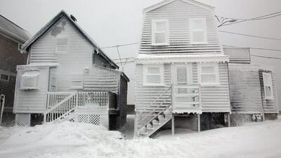 Frosted homes battered by wind in Massachusetts. AP Photo/The Quincy Patriot Ledger, Gary Higgins