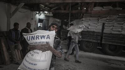 A Palestinian refugee carries at the United Nations food distribution centre in Al Shateaa refugee camp in Gaza. Mohammed Saber / EPA