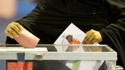 A woman casts her vote at the Fujairah Exhibition Centre.