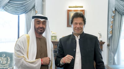 Sheikh Mohamed bin Zayed and Imran Khan, Prime Minister of Pakistan, show off their Special Olympics wrist bands at the Prime Minister's residence in Islamabad. Rashed Al Mansoori / Ministry of Presidential Affairs
