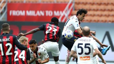 Genoa's Gianluca Scamacca scores an own goal under pressure from Fikayo Tomori of Milan. Getty