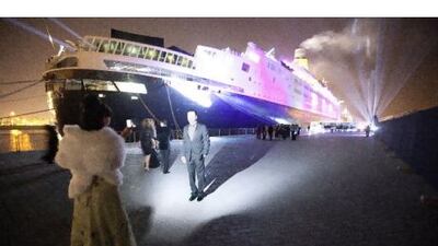 Guests take a picture before boarding the QE2 for its New Year's Eve party on Saturday night. Jaime Puebla / The National