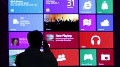 A man takes pictures at a Windows 8 promotion in Tokyo. The system has been described as faster and more secure than its predecessors. Toru Hanai / Reuters
