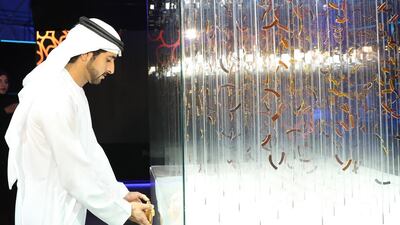 Sheikh Hamdan affixes a plaque onto artwork by Thomas Medicos which was inspired by the Expo 2020 logo. Wam