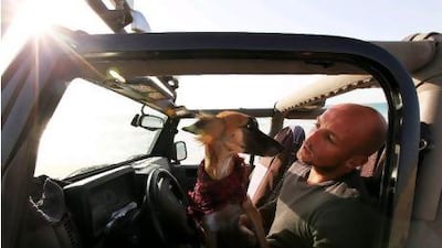 Marcus Taylor with his Jeep and dog Scout at Jumeirah Beach, Dubai. Taylor is thinking of trading up for a 4x4 large enough to carry all his outdoor gear.