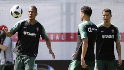 Portugal defender Bruno Alves, left, controls the ball next to defender Pepe, centre, and forward Cristiano Ronaldo during a training session at the team's base camp in Kratovo. AFP