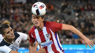 Atletico’s Filipe Luis headers the ball away from Tottenham Hotspur’s Erik Lamela during the International Champions Cup football match between English Premier League team Tottenham Hotspur and Spanish club Atletico Madrid in Melbourne on July 29, 2016. / AFP / Paul Crock