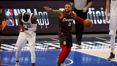 Portland Trail Blazers guard Damian Lillard reacts to a call of a jump ball as Dallas Mavericks forward Dorian Finney-Smith celebrates. AP