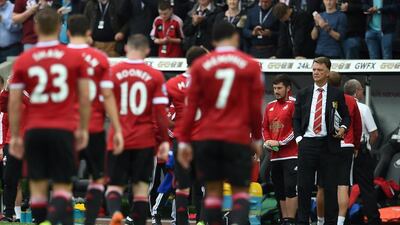 Manchester United manager Louis van Gaal watches his players lave the pitch following their defeat to Swansea City on Sunday. Paul Ellis / AFP