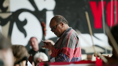 Jones conducting the orchestra during rehearsals on stage for the We are the Future humanitarian concert in Rome in 2004. Getty Images