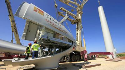 Employees work on the nacelle of an E-70 wind turbine during its installation at a wind farm in Meneslies, France. Benoit Tessier / Reuters