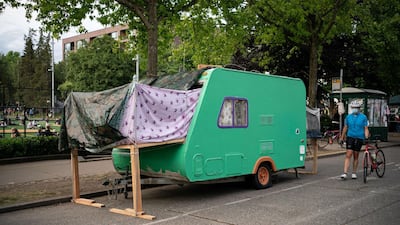 A person walks by a camping trailer in the so-called "Capitol Hill Autonomous Zone." Getty Images/AFP