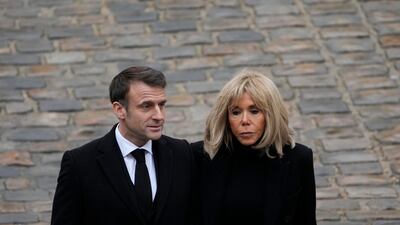 President Macron and his wife Brigitte leaving after the ceremony. AP