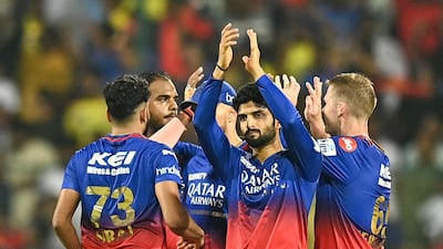 Royal Challengers Bengaluru's players celebrate after the dismissal of Chennai Super Kings' MS Dhoni, caught by Swapnil Singh off the bowling of Yash Dayal. AFP