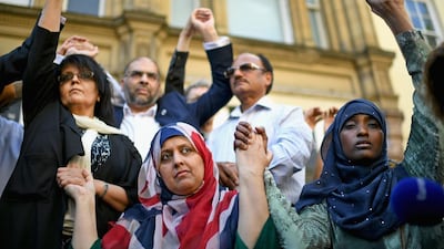 Manchester resident Gulnar Bano Kham Ghadri wears a Union Jack head scarf during a multi-faith vigil at the city's St Ann's Square on May 24, 2017. Jeff J Mitchell / Getty Images