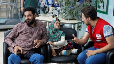 Maya chats with a member of the Turkish Red Crescent, which brought Maya to Istanbul from a camp in Syria's Idlib province. Reuters