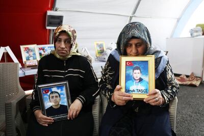 Mothers of young people who they say were recruited by the PKK hold their sons' pictures in the Turkish city of of Diyarbakir on Monday. Reuters