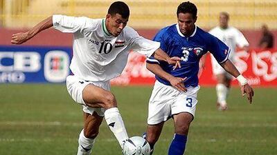 Iraq's Yunis Khalaf, left, fights for the ball against Kuwait's Saqer Al Antari during a friendly match in Amman. The two rivals renew their battles on the pitch in the Gulf Cup of Nations starting Saturday.