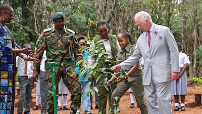 King Charles III plants a tree with environmental campaigner Karen Kimani during a visit to Karura urban forest to highlight the role of green spaces and forests in sustainable cities. Getty Images