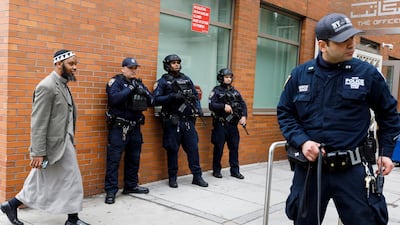 New York City police, including officers from the department's Counterterrorism Unit, guard the Islamic Cultural Centre as people arrive for prayers. EPA