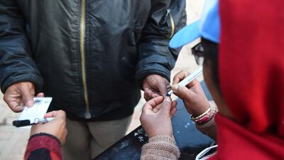 A Nepali election official marks a voter's finger in Kathmandu. Prakash Mathema / AFP Photo